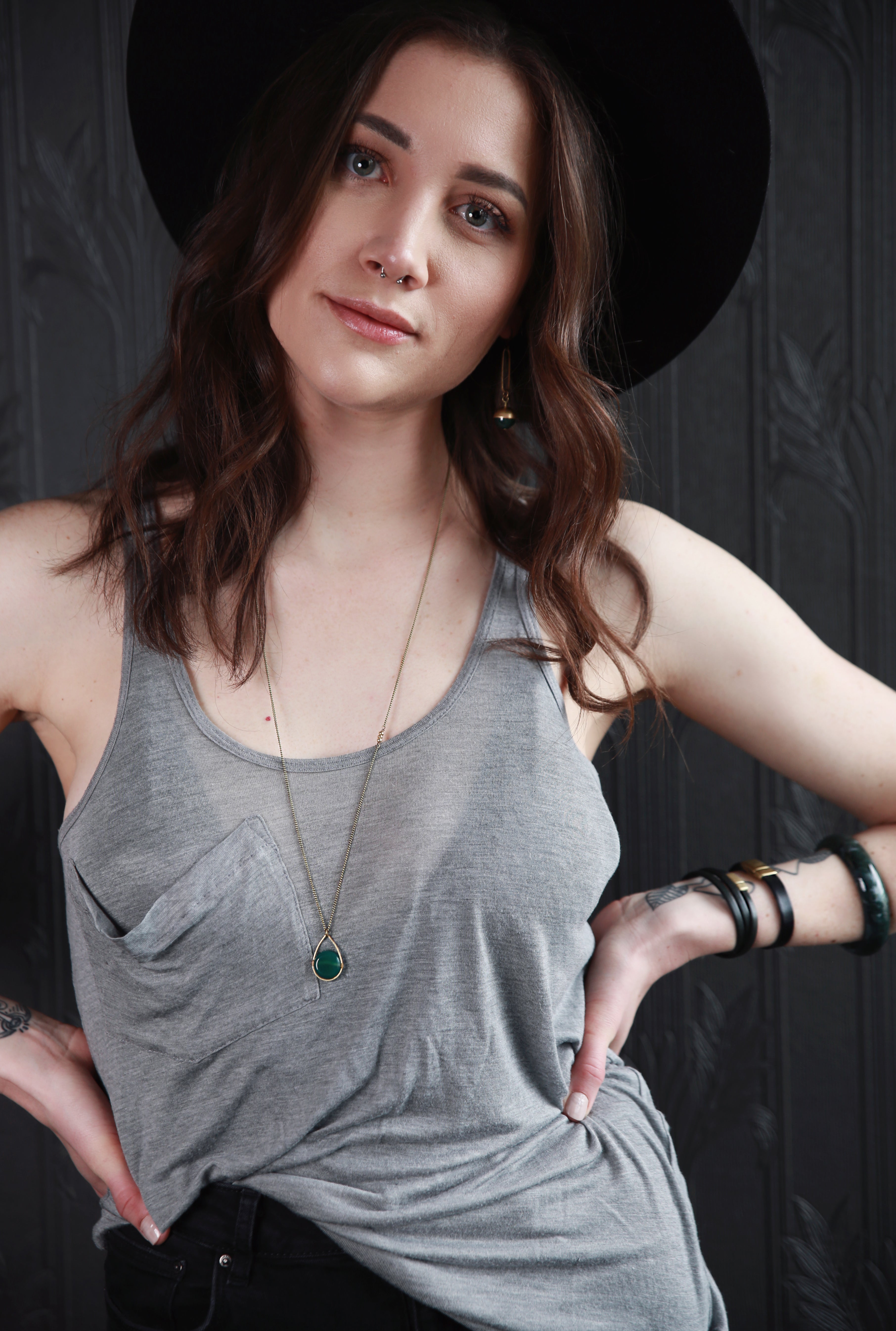 Young woman modeling brass, leather and stone jewelry crafted by local Milwaukee Jewelry Designers, Cival Collective.