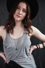 Young woman modeling brass, leather and stone jewelry crafted by local Milwaukee Jewelry Designers, Cival Collective.