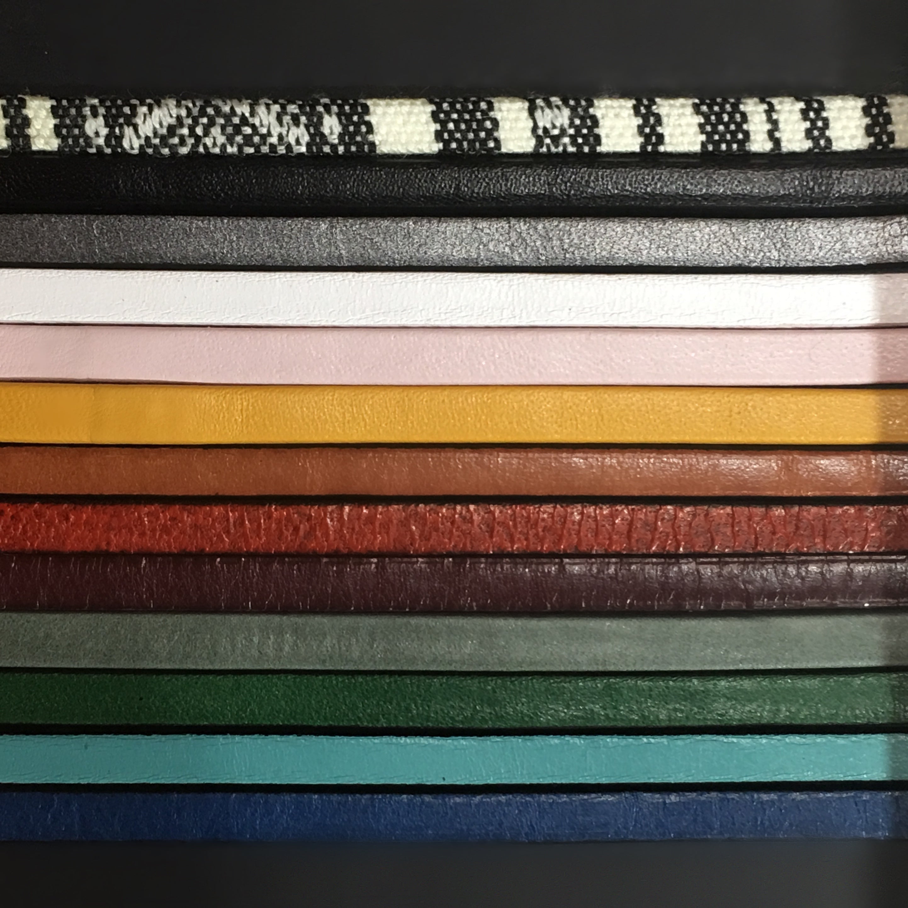 13 strips of different colored leather to display the options used to make the "Aida" bracelet.