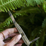 Double bladed solid brass pocket knife, with nail file 