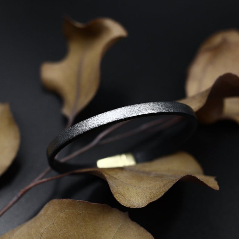 Close up of "Aime" leather bracelet in gunmetal metallic gray with magnetic clasp.