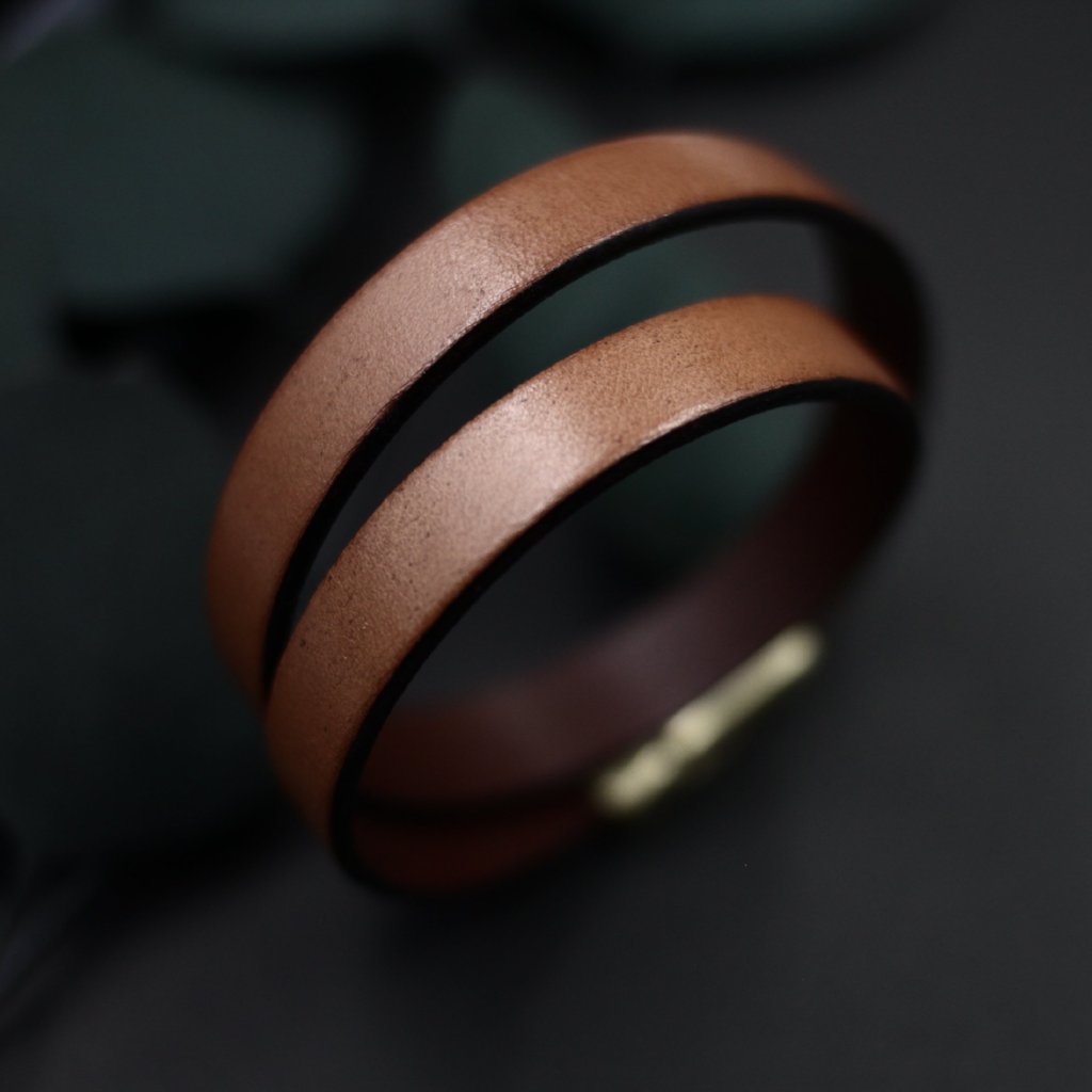 Detail close up of wide, tan 10mm leather double wrap bracelet with magnetic clasp.