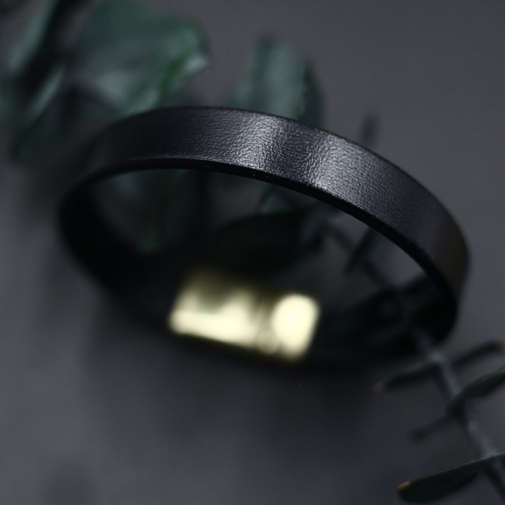 Close up of black, wide Italian leather bracelet with magnetic clasp by CIVAL Collective.