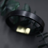 Close up of black, wide Italian leather bracelet with magnetic clasp by CIVAL Collective.
