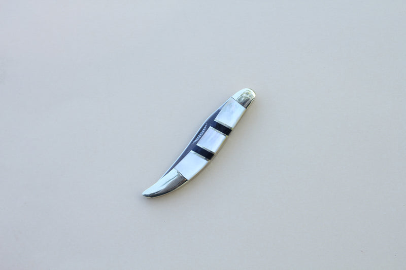 Closed toothpick stainless steel pocket knife with mother of pearl and onyx inlay handle.  5 inches long with brass bolsters.