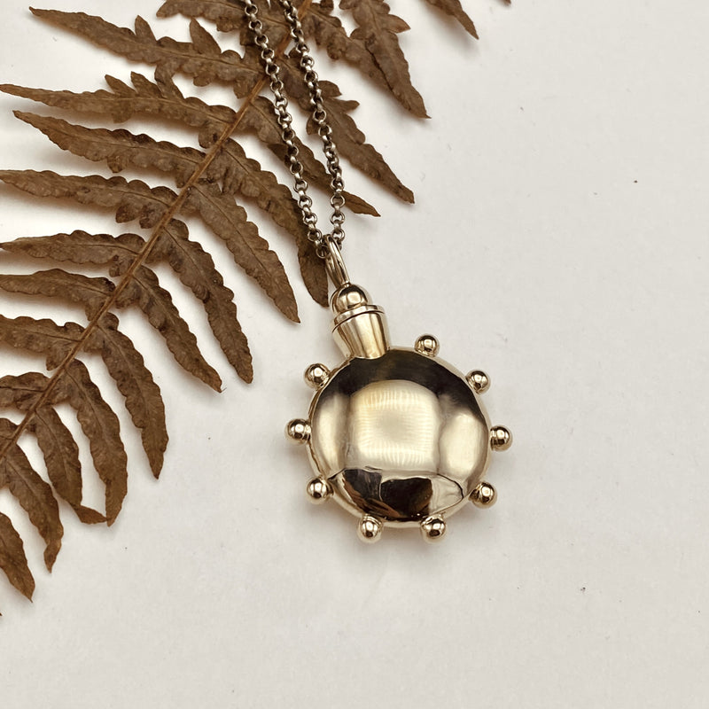 Cast Brass dot design vessel necklace from Cival Collective, a jewelry store in Milwaukee WI