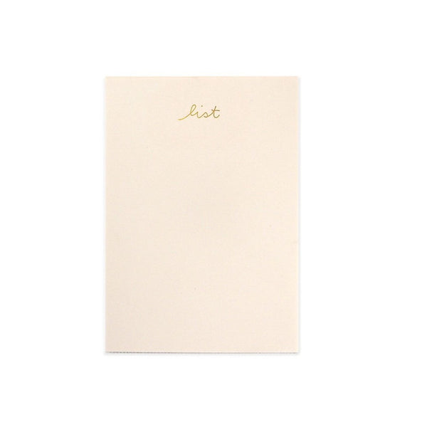 light pink notepad with gold lettering "list" on the top of page