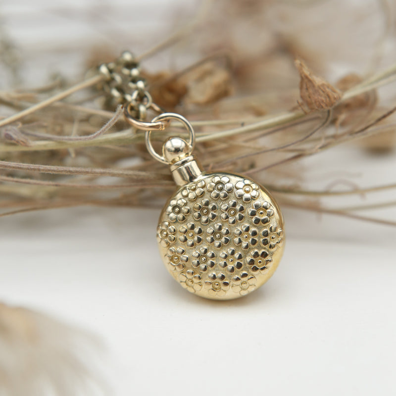 a brass floral vessel necklace designed at Cival Collective, a jewelry store in Milwaukee