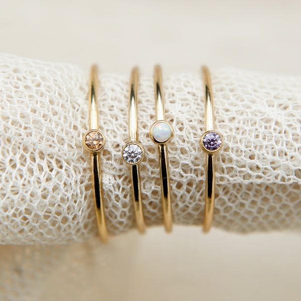 set of four gold fill stacking rings in Brown Topaz, White CZ, Opal, and Tanzanite
