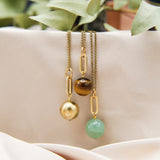 One aventurine, one tiger's eye, and one brass round hanging from 18mm heavy brass ovals on brass chains