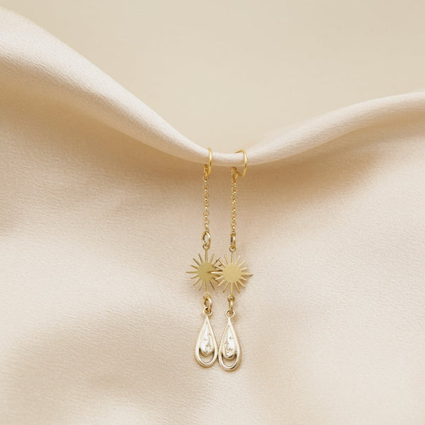 close up of hester earrings, sparkle cast brass tear drop earrings with retro star drops
