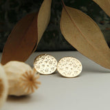 Close up of paloma earrings, cast brass with starry motif, cast brass designed in house at Cival Collective, Milwaukee WI 