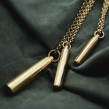 Three brass canister necklaces designed at Cival Collective, a jewelry store in Milwaukee WI