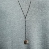 Rosary style "Vie" necklace on satellite chain with a 2 inch drop and small brass locket at the end.