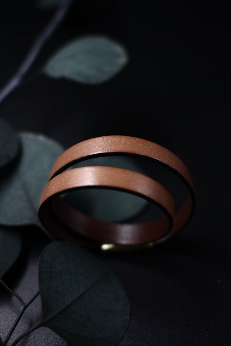 CIVAL Collective's "Acer" 10mm wide tan leather bracelet, double wrapped and closed with magnetic clasp, displayed on black background.