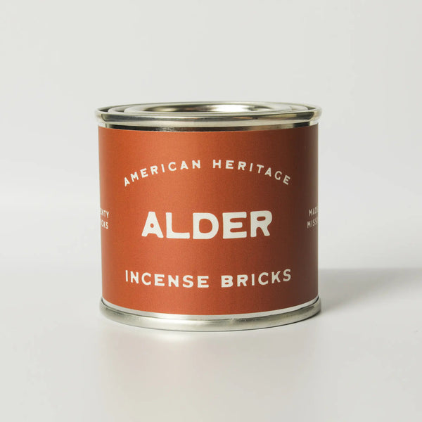 image of tin container on white background. Product labeled "american Heritage Alder incense bricks" in white on brick colored label