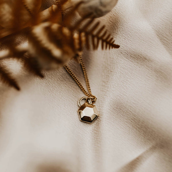 small cast hexagon pendant on a brass chain