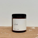 Candle in amber jar, labeled love magic candle 