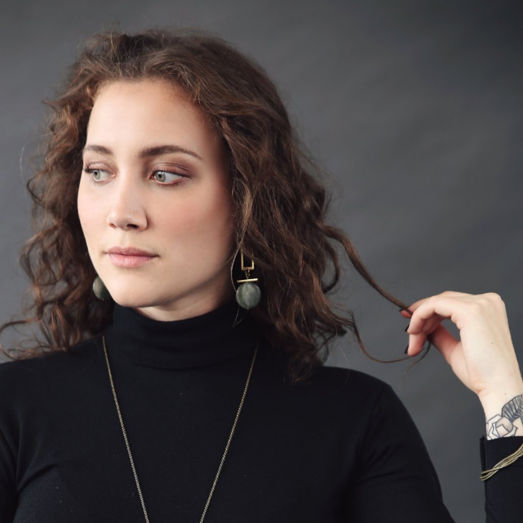 Model wearing "Elise" modern brass and stone earrings designed by CIVAL Collective.