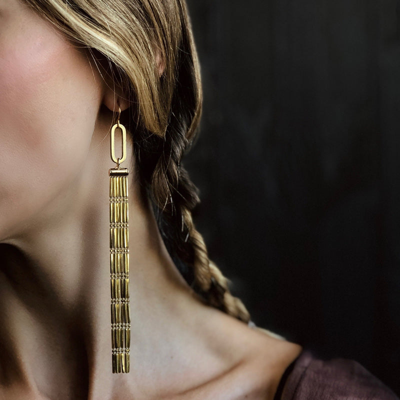 close up of frieda chandelier earrings made with lightweight faceted beaded brass chain
