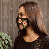 Floral mask on model with brass mask chain attached 