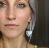 Sacred heart and sun burst drop earrings on model, mother of pearl heart