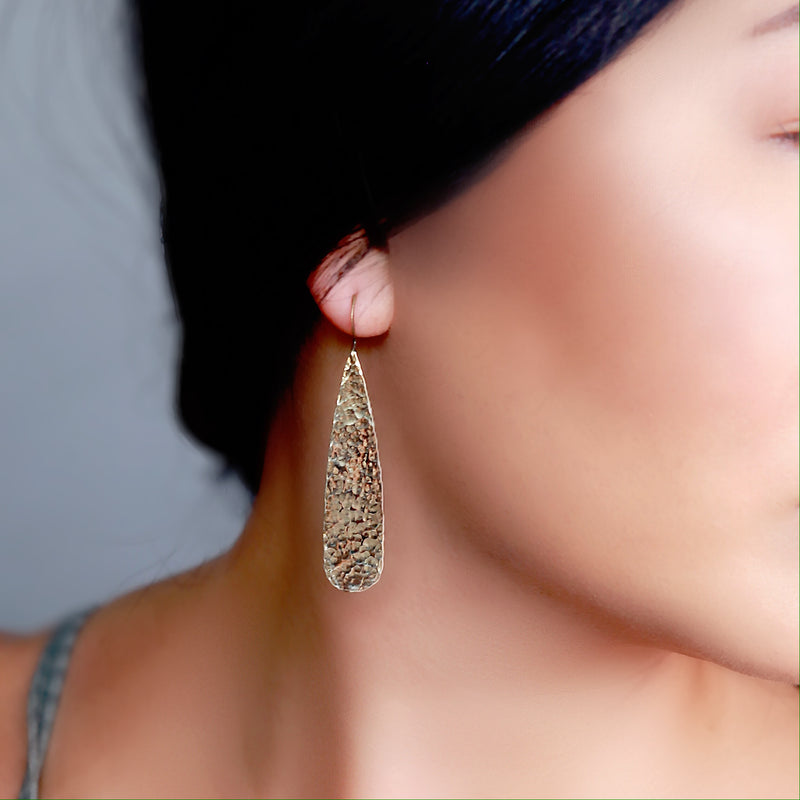 hammered brass teardrop earrings on model 