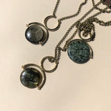 Three statement necklaces featuring gold sheen obsidian, green seraphinite and laboradorite at Cival Collective, a jewelry store in Milwaukee WI