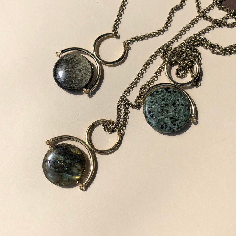 Three statement necklaces featuring gold sheen obsidian, green seraphinite and laboradorite at Cival Collective, a jewelry store in Milwaukee WI