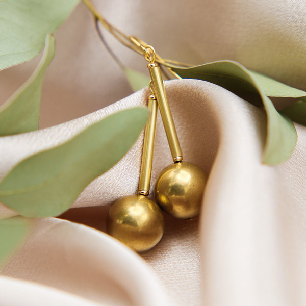 close up of Marit drop earring, brass post and ball drops 