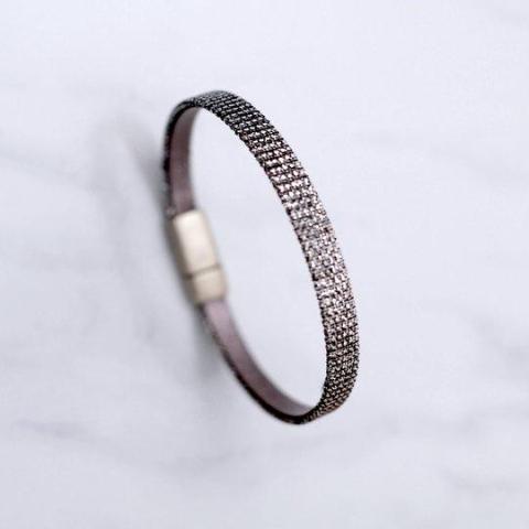 Close up of the "Mica" shimmer woven fabric & leather bracelet with magnetic clasp made by Cival Collective.